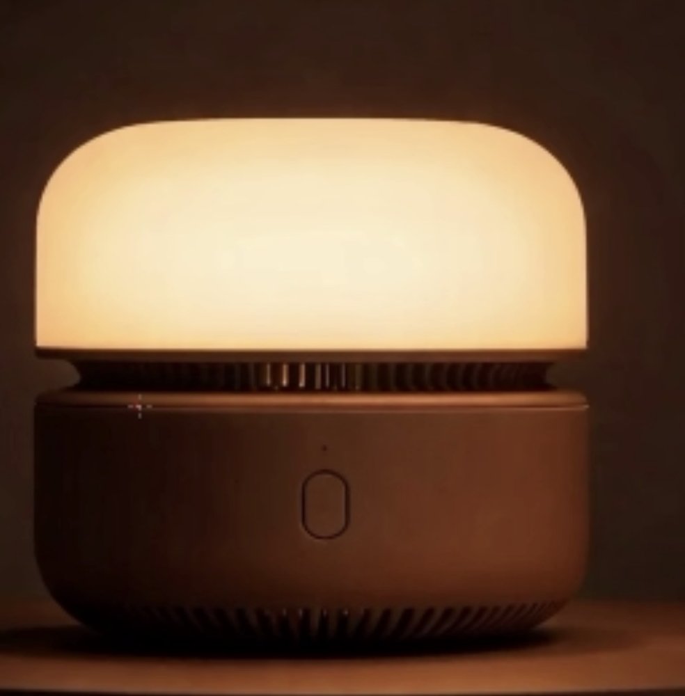 The Northlight bedside lamp softly glowing with warm amber light.